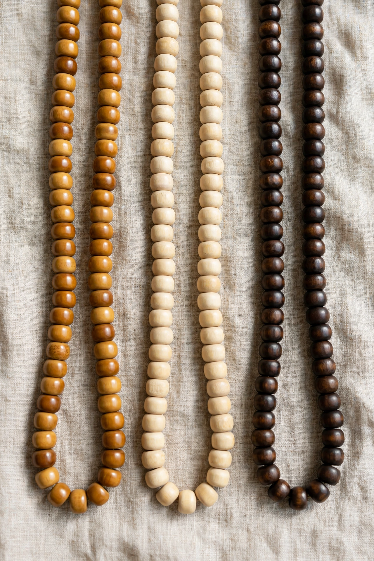 Bamboo bead strands in natural, honey, and dark-stained finishes