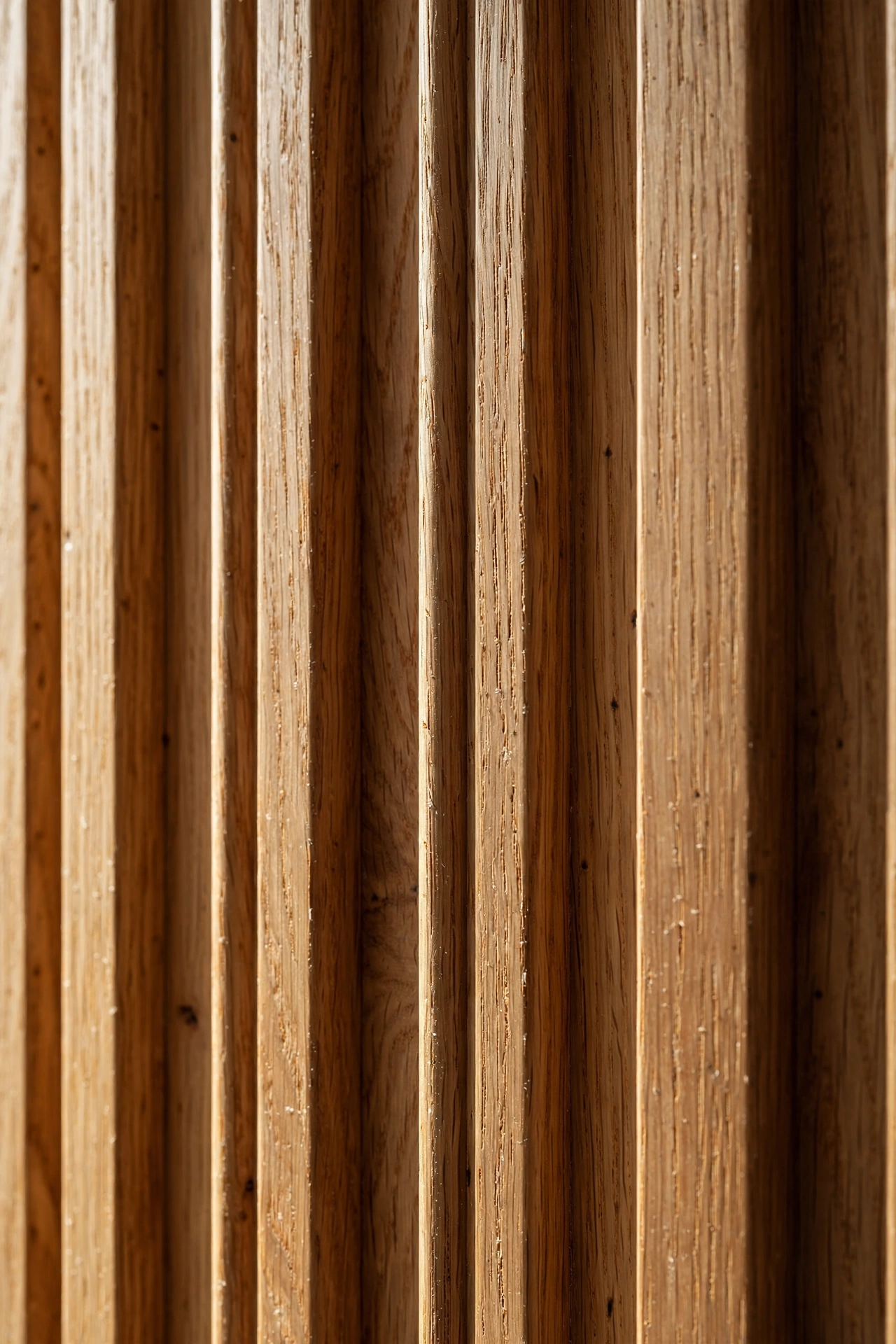 Close-up of warm oak fluted wall panel ribs