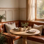 Cognac leather banquette dining nook with a wooden pedestal table